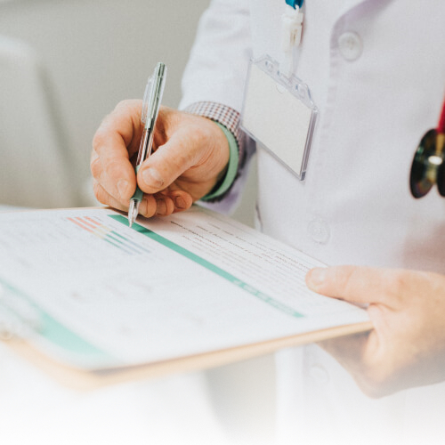 Doctor writing on a clipboard
